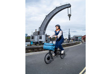 Woman riding Brompton bike