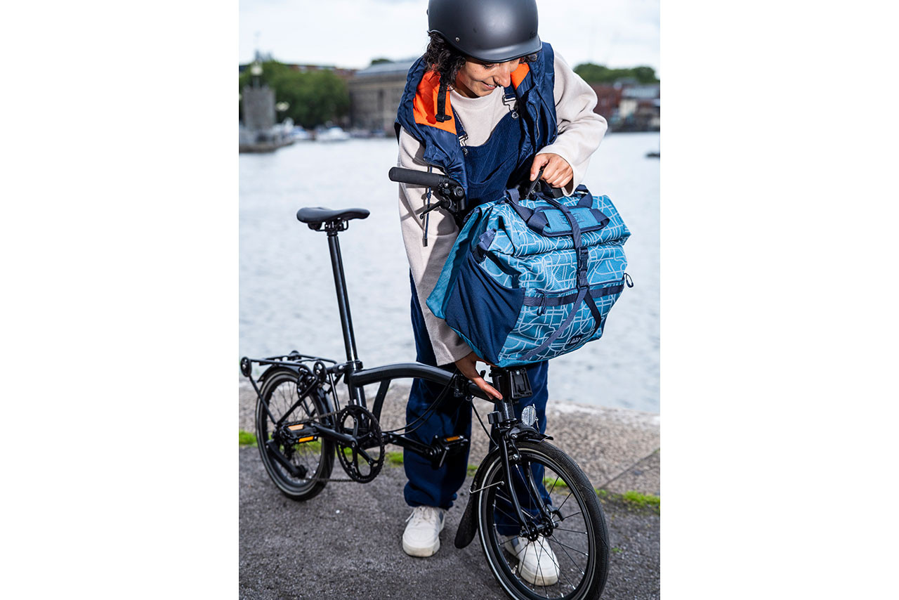 Woman attaching bag to Brompton Bike